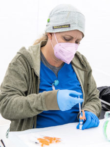 nurse preparing covid vaccines